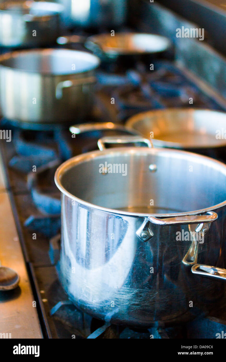 Cooking pots and pans on a gas stove Stock Photo - Alamy
