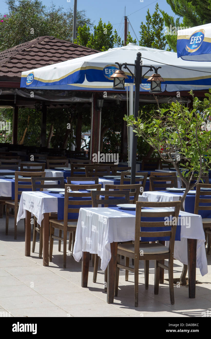 Tables and chairs set up outside at a restaurant Stock Photo