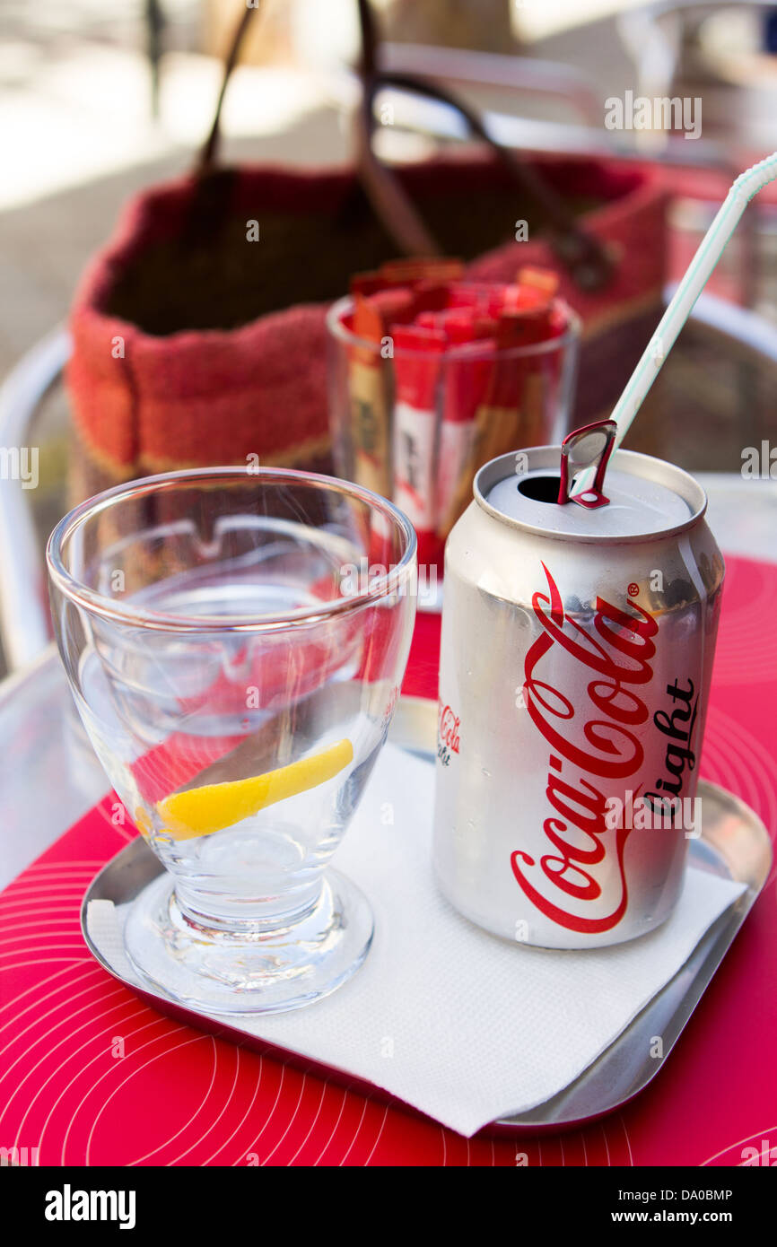 Can of Diet Coke with a straw and a glass with a slice of lemon Stock Photo