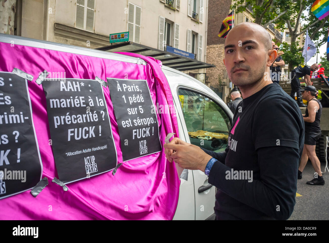 Paris, France, LGBT Group, Act Up Paris, Man Taping French protest poster  to side of Car in Annual Gay Pride Parade, (Aurelien) act up aids activist, volunteer ngo Stock Photo