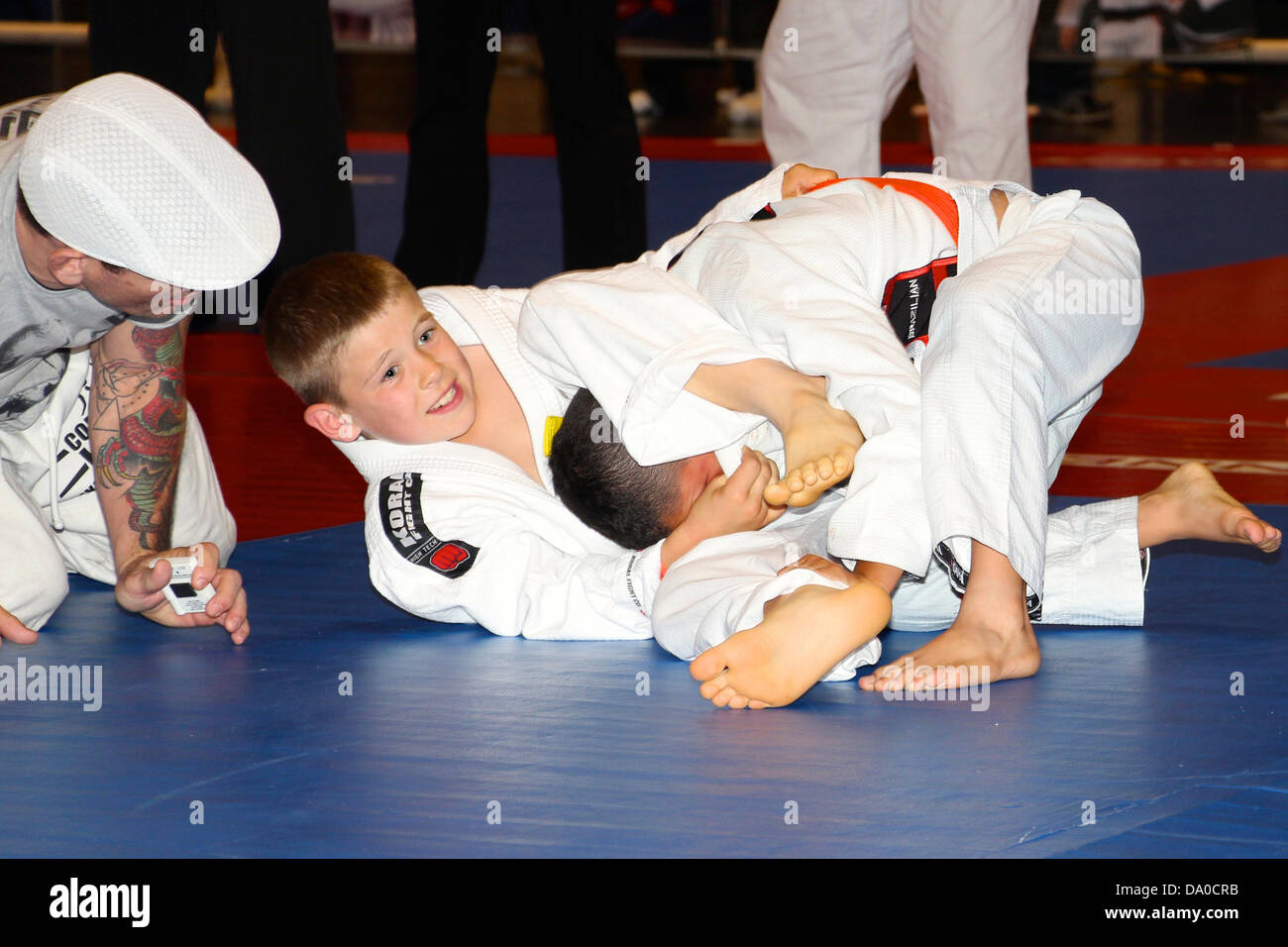 Children ages 4 to 12 compete in a jiu jitsu competition with four