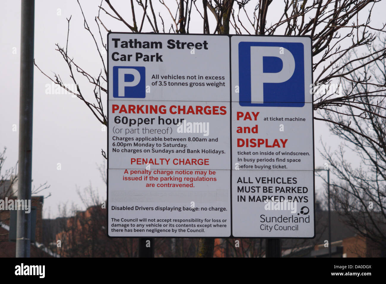 Pay and display car park sign showing parking charges, penalty charge