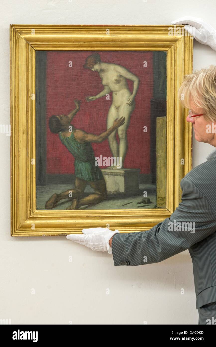 Culture referee Wilfried Hartleb rearranges the painting 'Pygmalion' by Franz von Stuck in the district gallery Passau in the castle of Neuburg Am Inn, Germany, 27 June 2013. The exhibition in the museum shows the life and artworks of Franz von Stuck. Photo: ARMIN WEIGEL Stock Photo