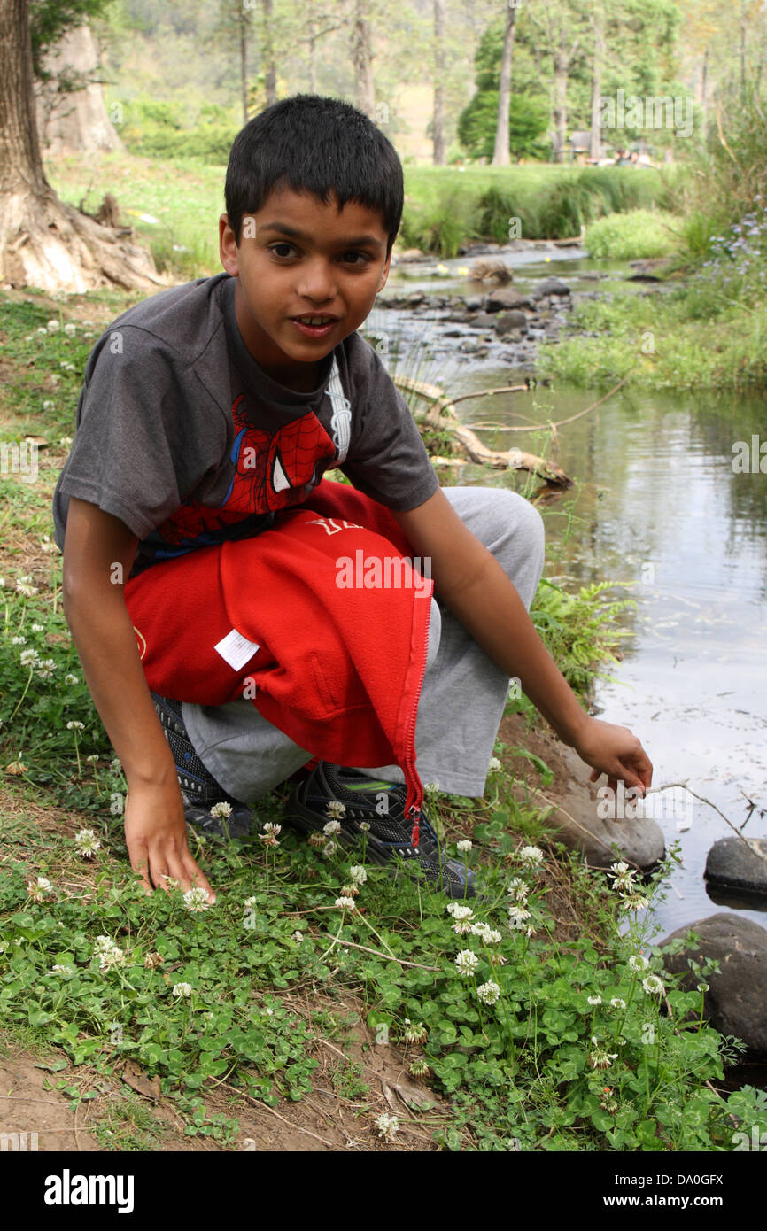 Boy crouching Stock Photo