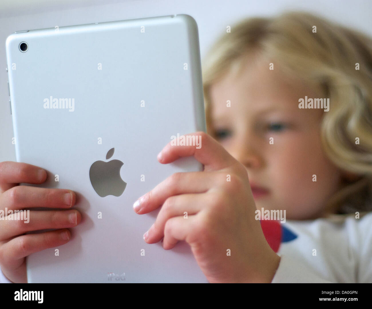Young girl using an iPad mini Stock Photo
