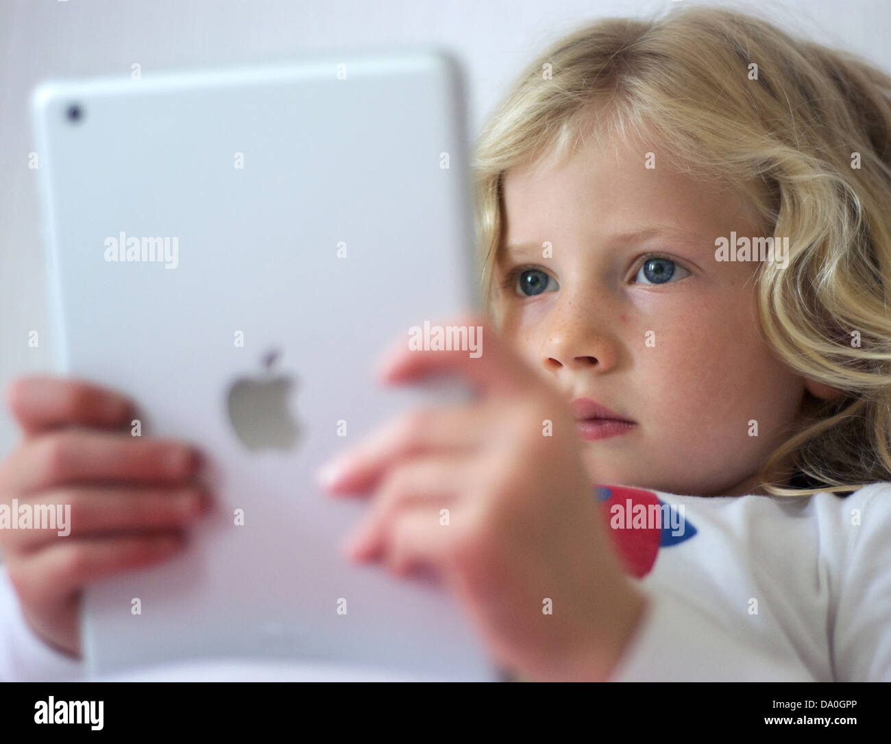Young girl using an iPad mini Stock Photo