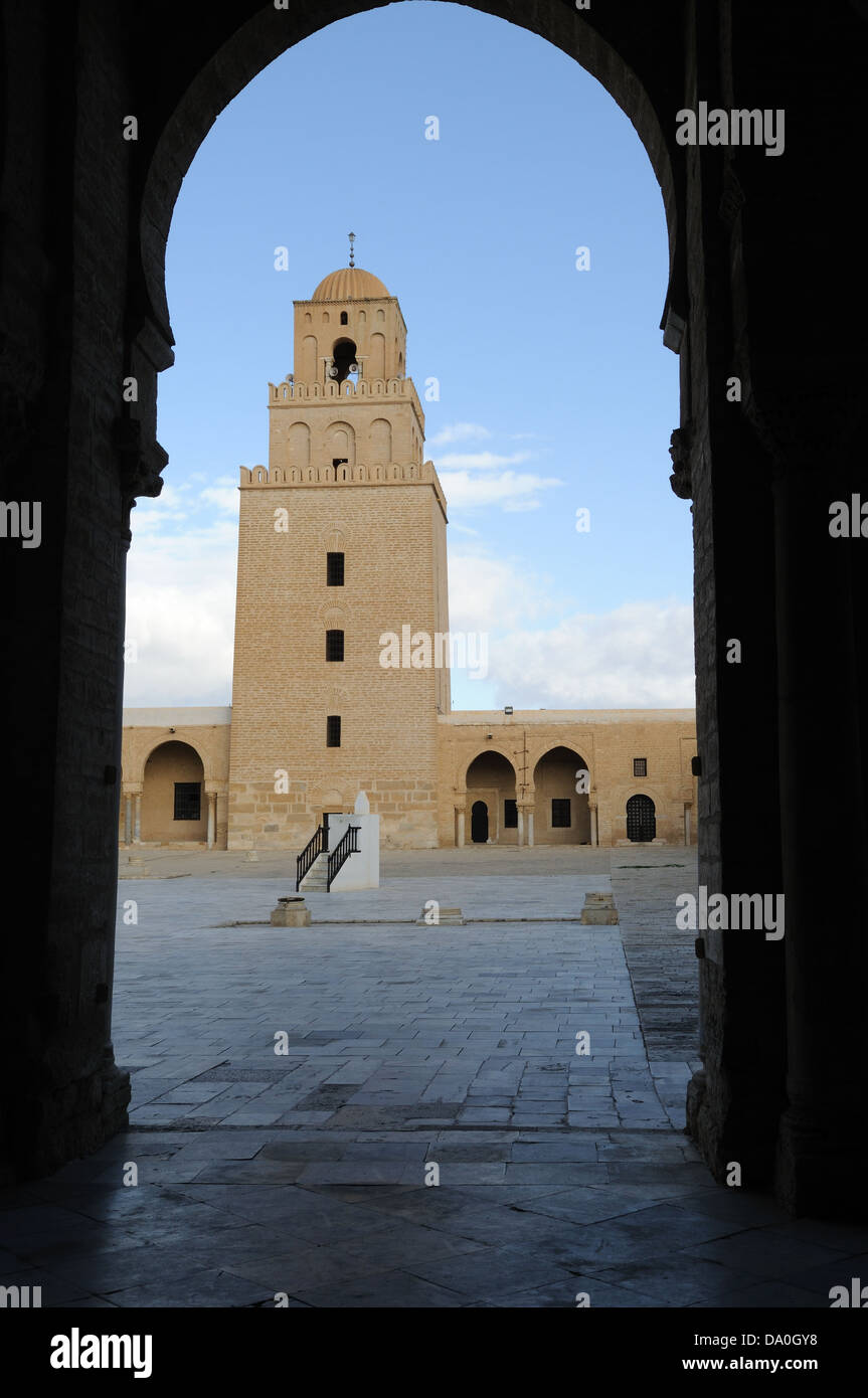 The minaret of the Great Mosque viewed through a horseshoe shaped arch Kairouan Tunisia Stock Photo