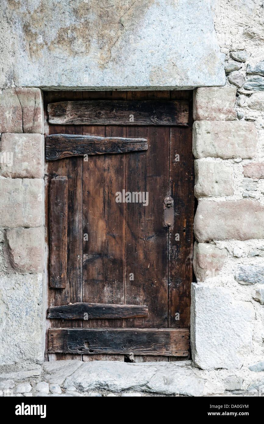 Old wooden door and stony wall Stock Photo - Alamy