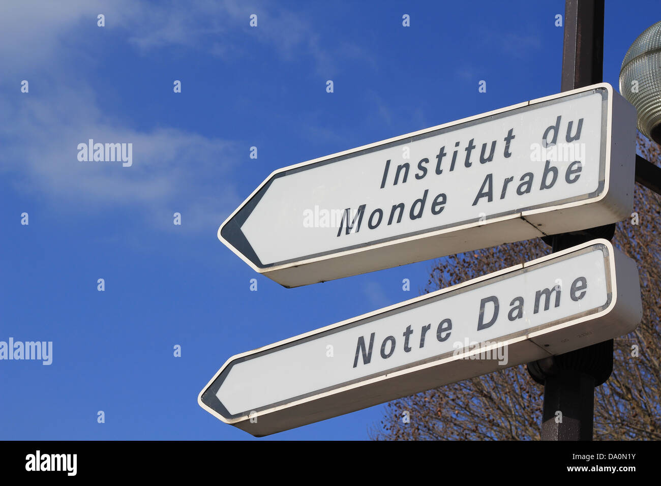 Street signpost indicating direction to Notre-Dame cathedral and Institut du Monde Arabe Stock Photo