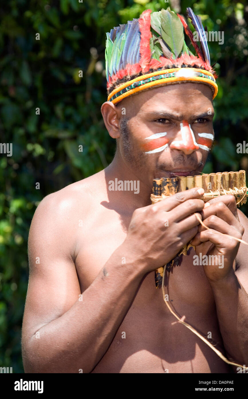 Simbu clansmen play hand-made flutes for visitors, Warabena village, Asaro District, near Goroka, Papua New Guinea Stock Photo