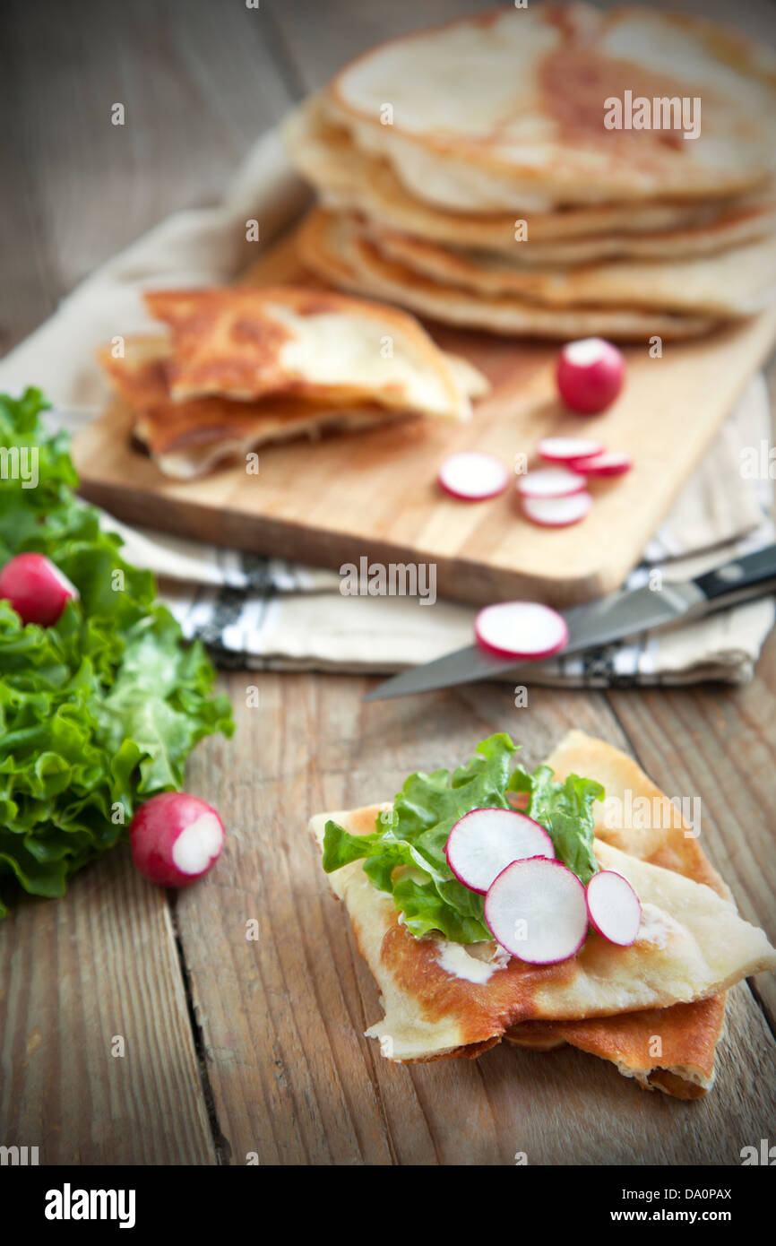 Homemade milk flat bread with cream cheese, lettuce and radish Stock