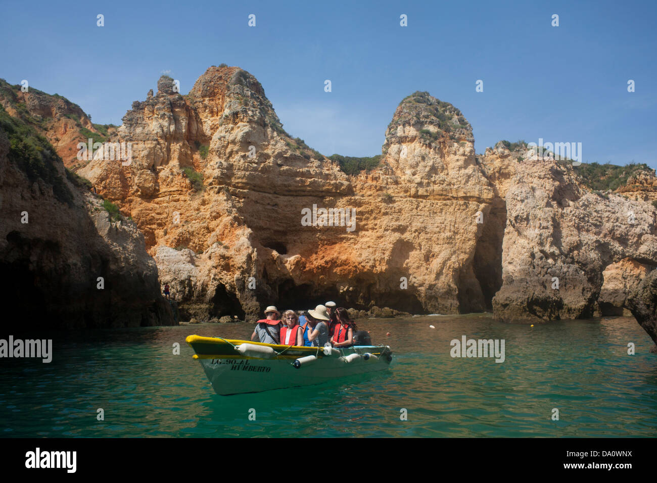 Boat trip in cove surrounded by typical unusual Algarve rock formations Ponta da Piedade Lagos Algarve Portugal Stock Photo