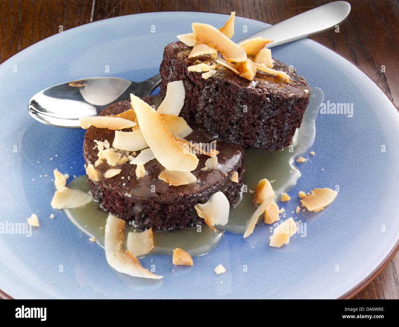 Chockablock chocolate cakes with warm Macadamia nut caramel Stock Photo ...