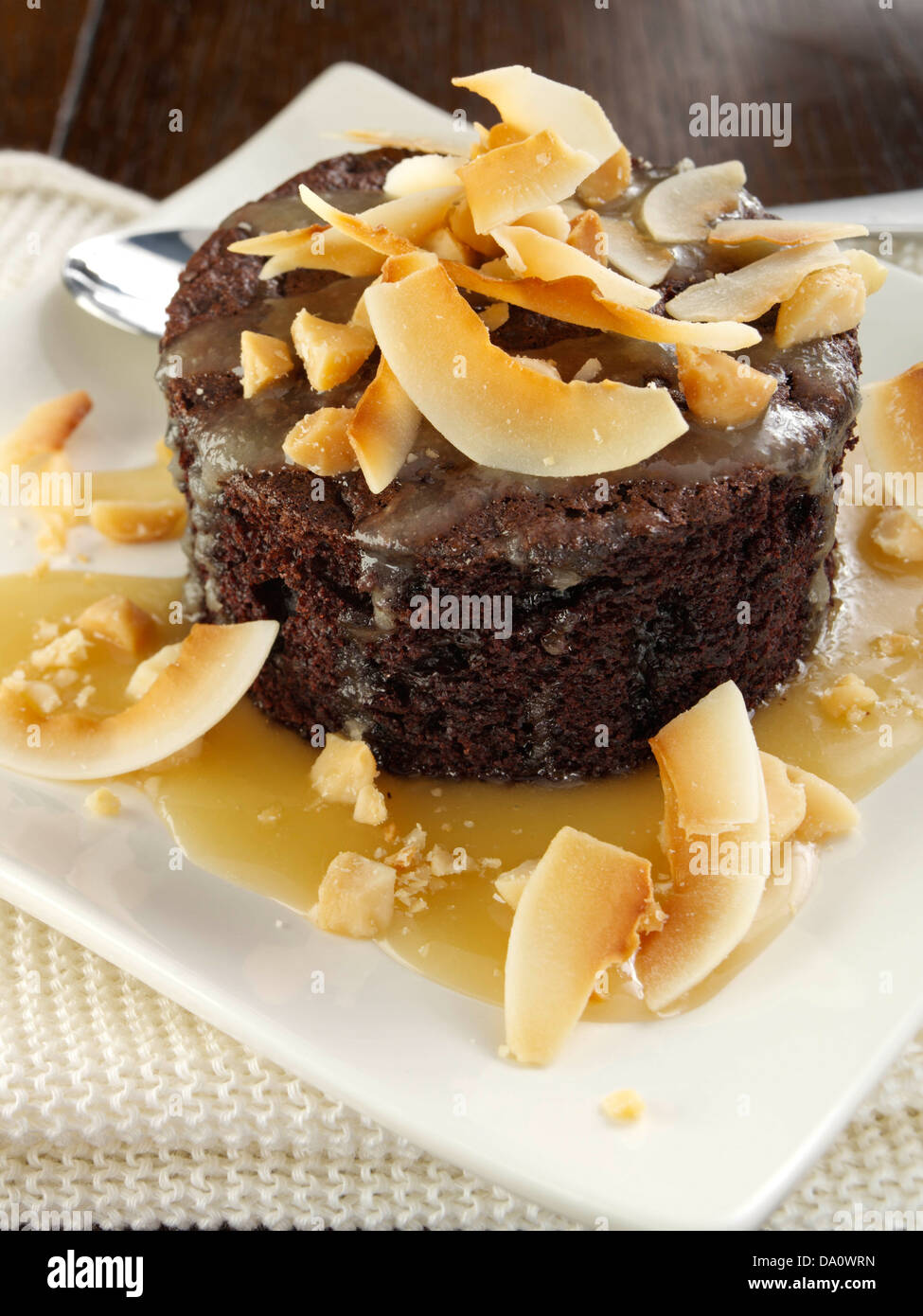 Chockablock chocolate cakes with warm Macadamia nut caramel Stock Photo ...