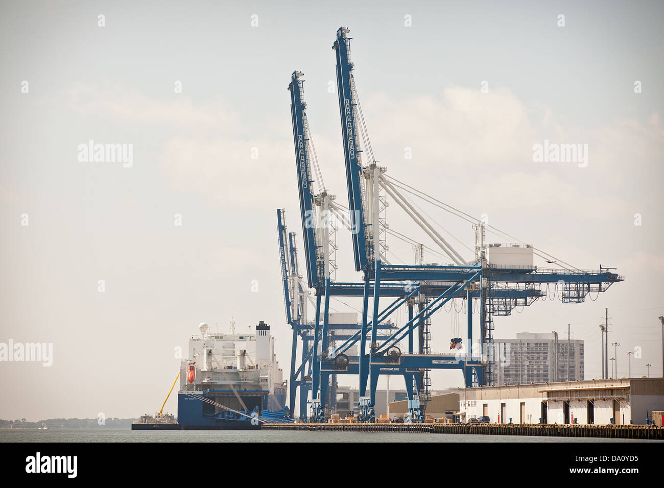 Cargo ship loads in the Port of Charleston in Charleston, SC Stock Photo