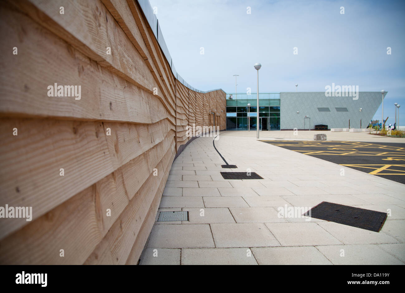 Porth Eirias Centre, Colwyn Bay showing creative shot of brand new wooden cladding & stone slabs and glass & metal building Stock Photo