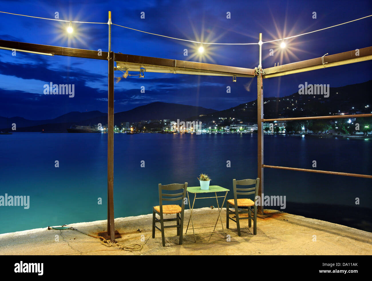 'Blue hour' at 'Akrogiali' restaurant, Marmari town, South Evia island, Central Greece. Stock Photo