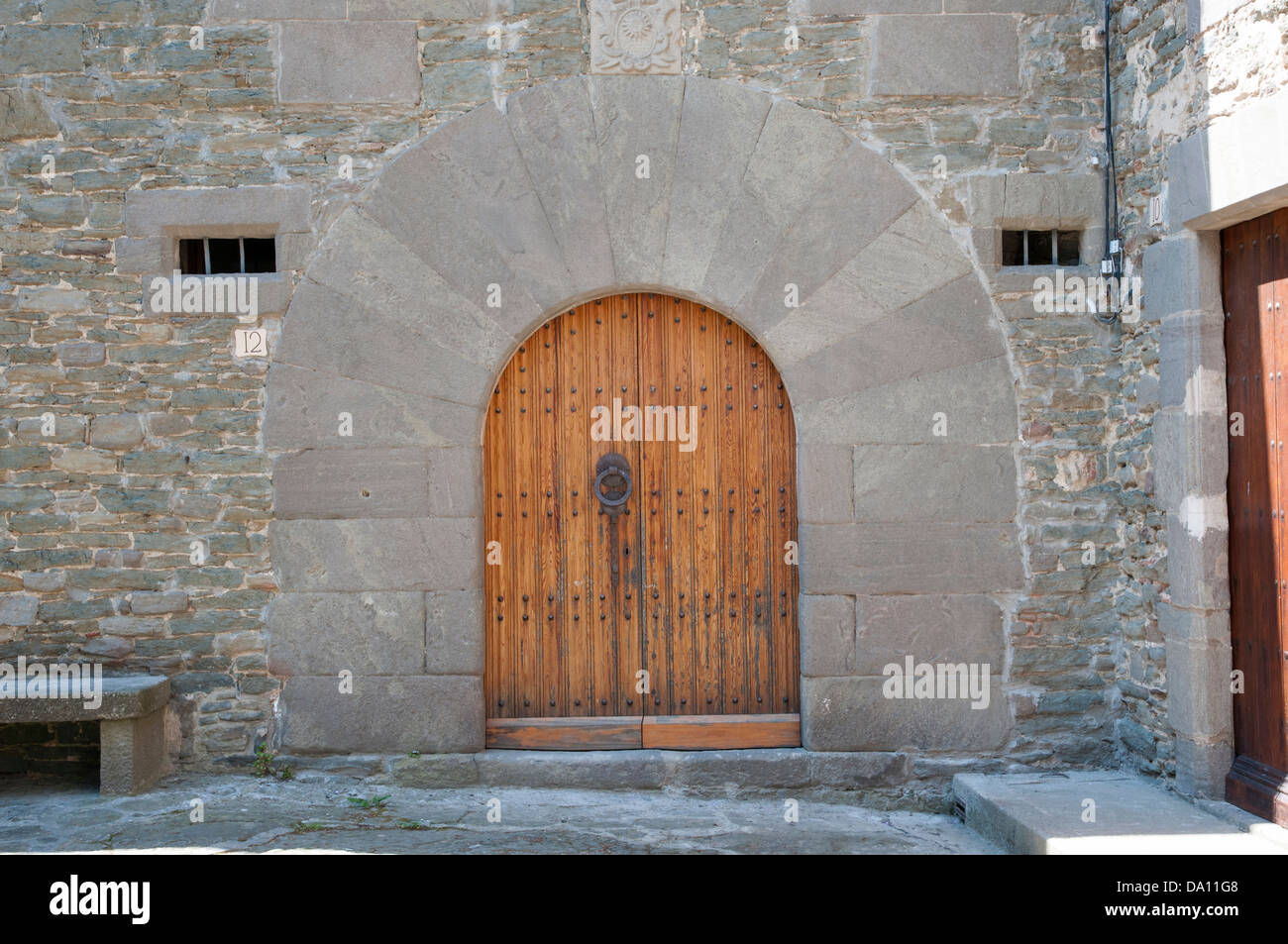 old wooden door with stone wall Stock Photo - Alamy