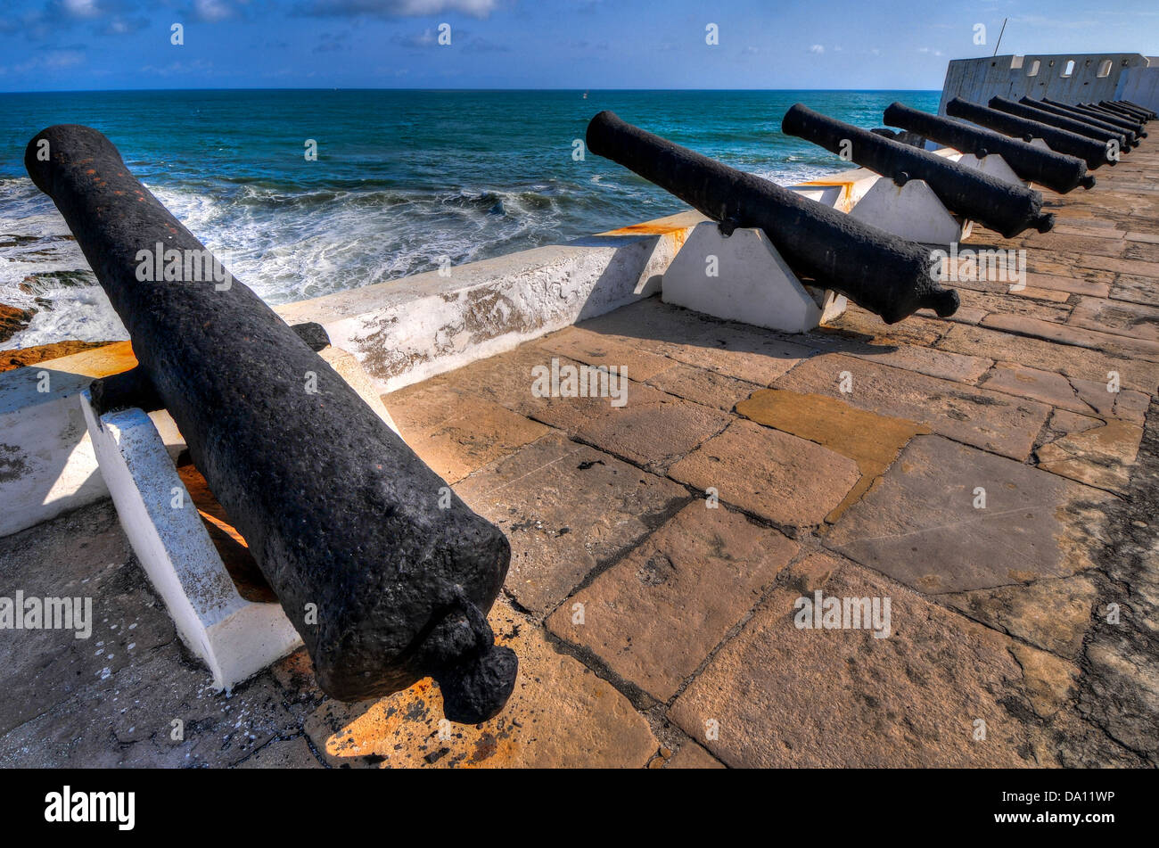 Cannons overlooking from Cape Coast Castle. Cape Coast Castle is a fortification in Ghana built by Swedish traders for trade. Stock Photo