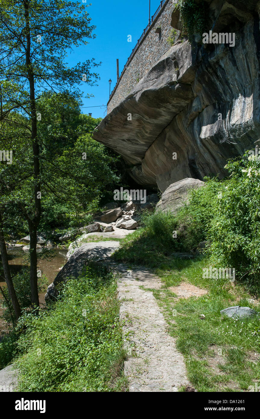 huge stone mountain surrounded by vegetation Stock Photo