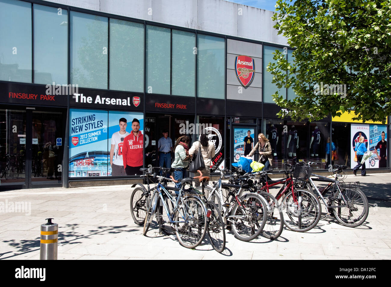 Bikes, bike racks and people in front of The Asenal shop, Finsbury Park