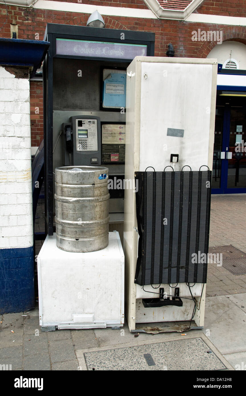 Old household appliances blocking the entrance to a public telephone box outside Drayton Park Station, Islington London England Stock Photo