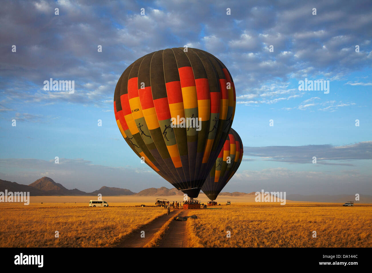 Launching hot air balloons in early light, Namib Desert, near Sesriem, Namibia, Africa Stock Photo