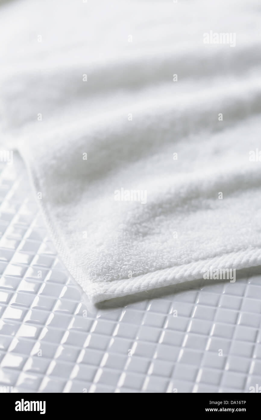 White towel on tiled floor Stock Photo Alamy