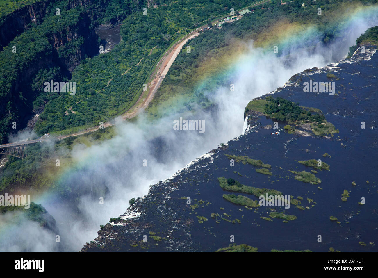 Helicopter, rainbow and spray, Victoria Falls or 'Mosi-oa-Tunya' (The Smoke that Thunders), and Zambezi River, Zimbabwe / Zambia Stock Photo