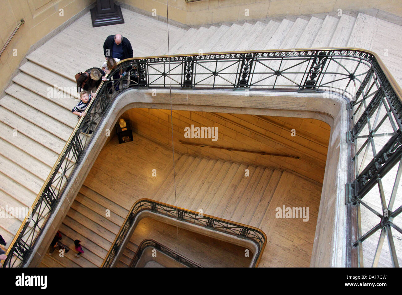 Interior stairs at the Franklin Institute of Philadelphia, Pennsylvania, where the pendulum is located and a family it watching. Stock Photo