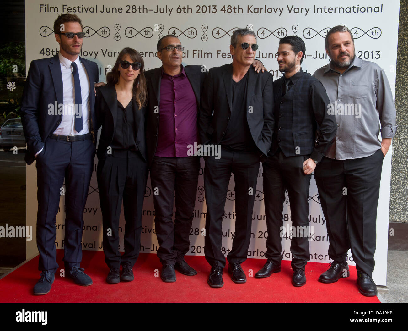Israeli movie delegation, from left to right, actor Michael Mark Aloni, actress Keren Berger, director Joseph Madmony, actor Alon Aboutboul, actor Tom Graziani a producer David Mandil, poses for photographers during the Makom Be Gan Eden (A Place in Heaven) presentation at the 48th Karlovy Vary International Film Festival in Karlovy Vary, Czech Republic, on Sunday, June 30, 2013. Madmony's A Place in Heaven is taking part in festival movie competition. (CTK Photo/Vit Simanek) Stock Photo