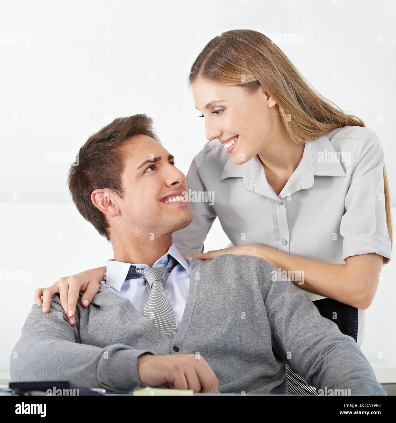 Happy business couple in office smiling at each other Stock Photo