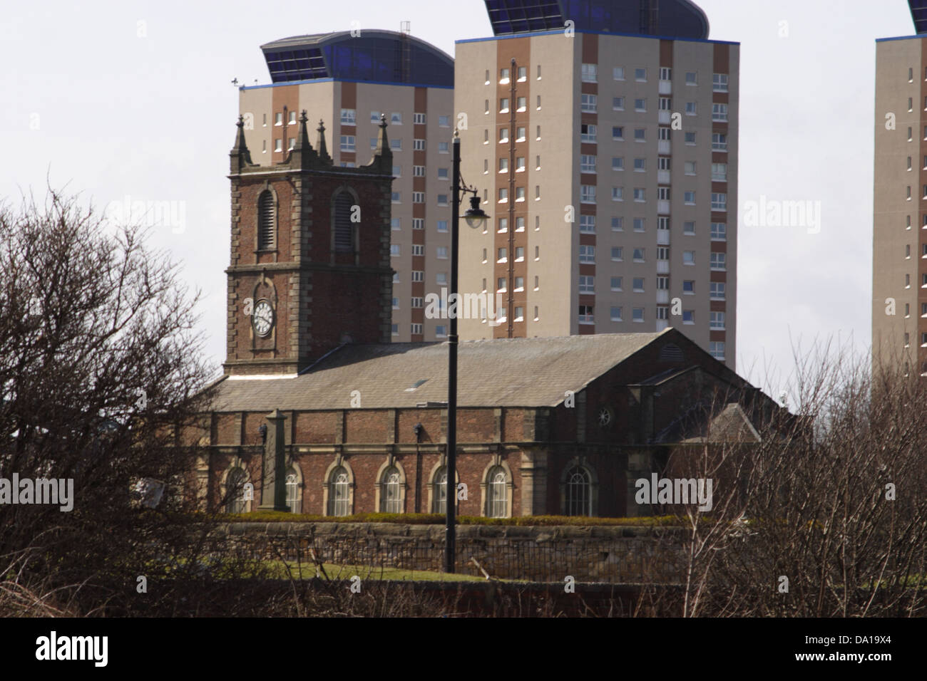 modern sky scrapers / tower blocks behind Holy Trinity Parish Church Stock Photo