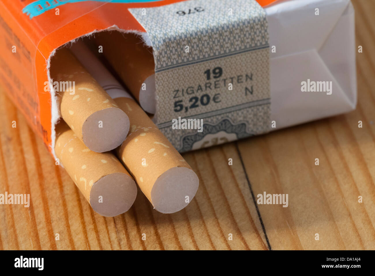 Germany, Laupheim, Packet of cigarettes on wooden table, close up Stock Photo