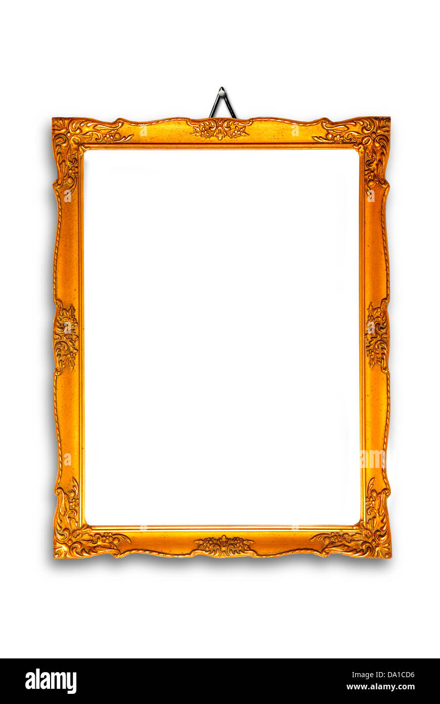 gold plated wooden picture frame hanging on a white wall Stock Photo