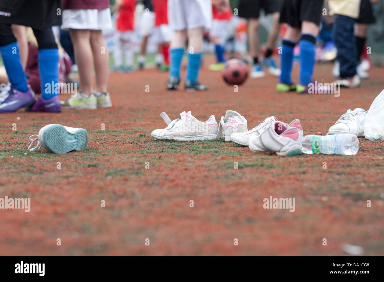 Discarded trainers and feet of children taking part in sport at Kent School Games, Canterbury High School Stock Photo