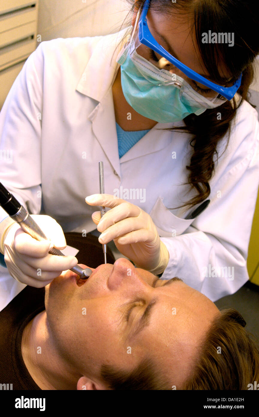 MAN RECEIVING DENTAL CARE Stock Photo