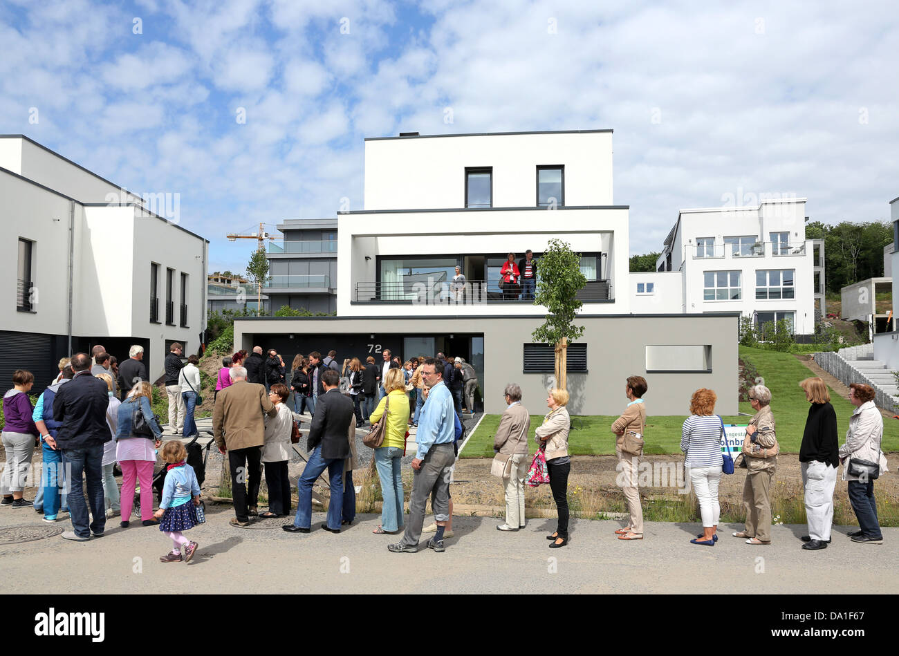 Visitors queue around to visit a newly build single-family house in the Lake Phoenix Estate of Dortmund, Germany Stock Photo