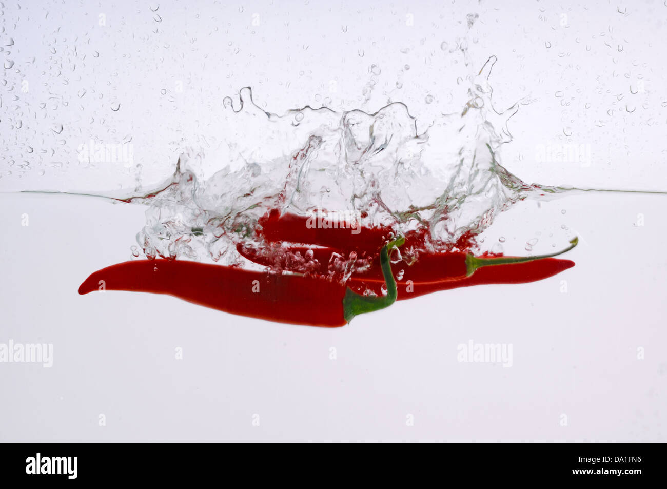 Chili pepper splashed into water Stock Photo Alamy