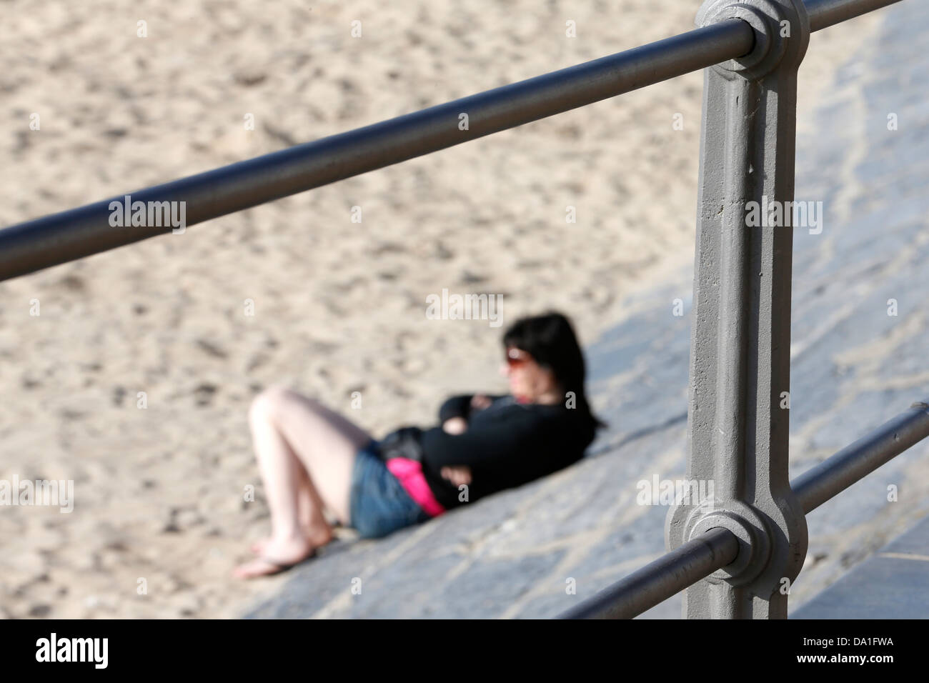 One woman laying on beach sea hi-res stock photography and images - Alamy