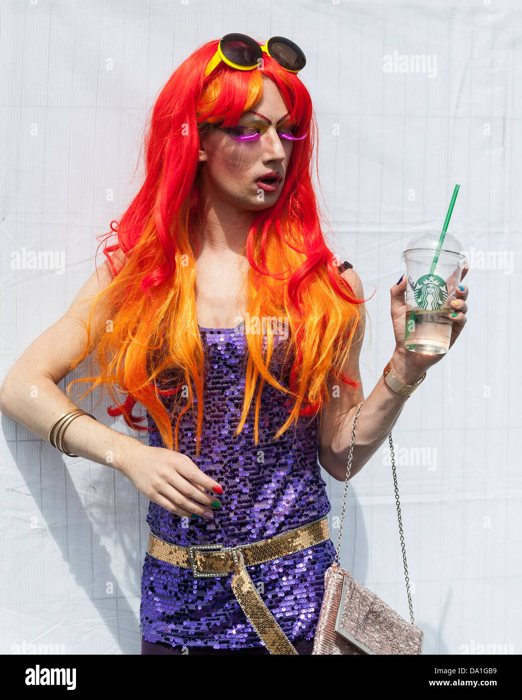 A transvestite posing in a vibrantly colourful wig. Stock Photo