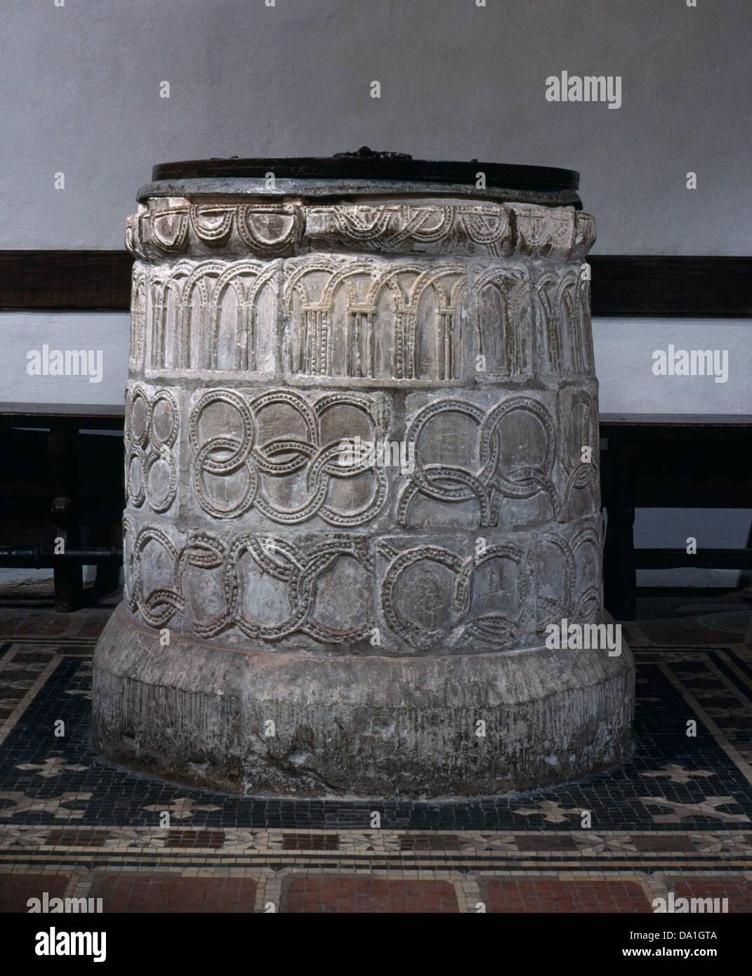 Saxon font in baptistery of St Martin's Church, Canterbury. Used for the adult Christian baptism of King Ethelbert c 598. Symbols of everlasting life Stock Photo