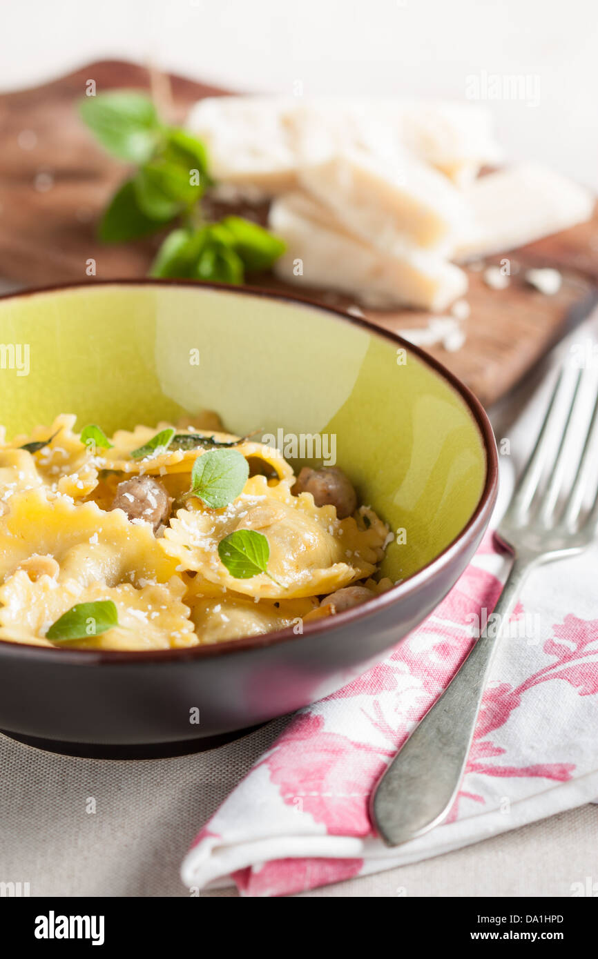 Modern yet rustic table set with a dish of meat and cheese ravioli Stock Photo