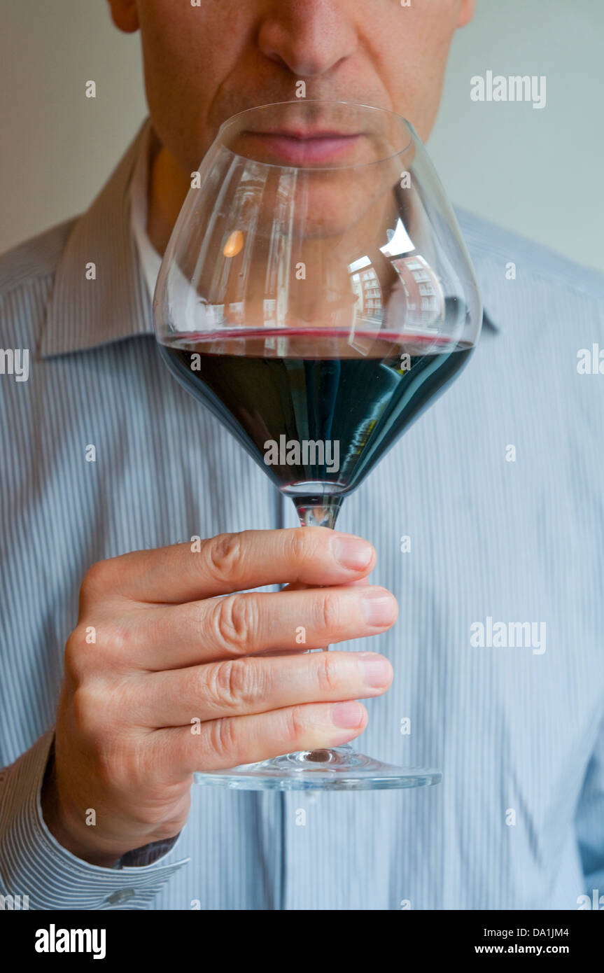 Man tasting a glass of red wine Stock Photo - Alamy