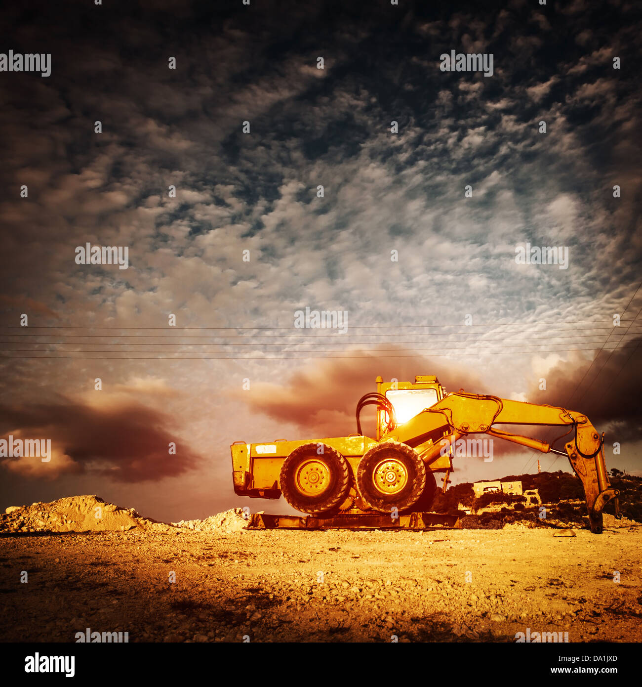 Big yellow excavator on sunset Stock Photo - Alamy
