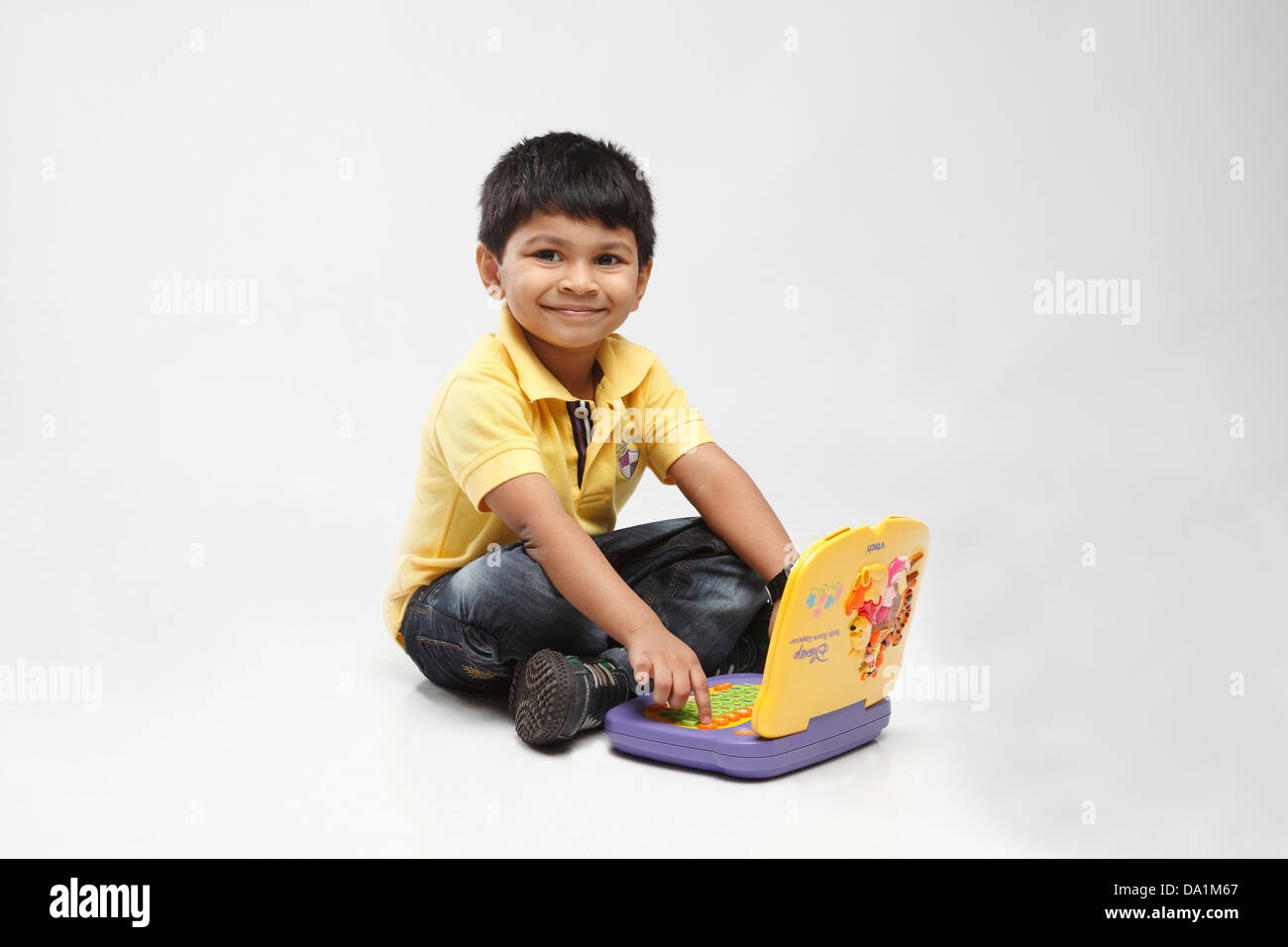 Little indian kid playing with laptop computer indoors Stock Photo - Alamy
