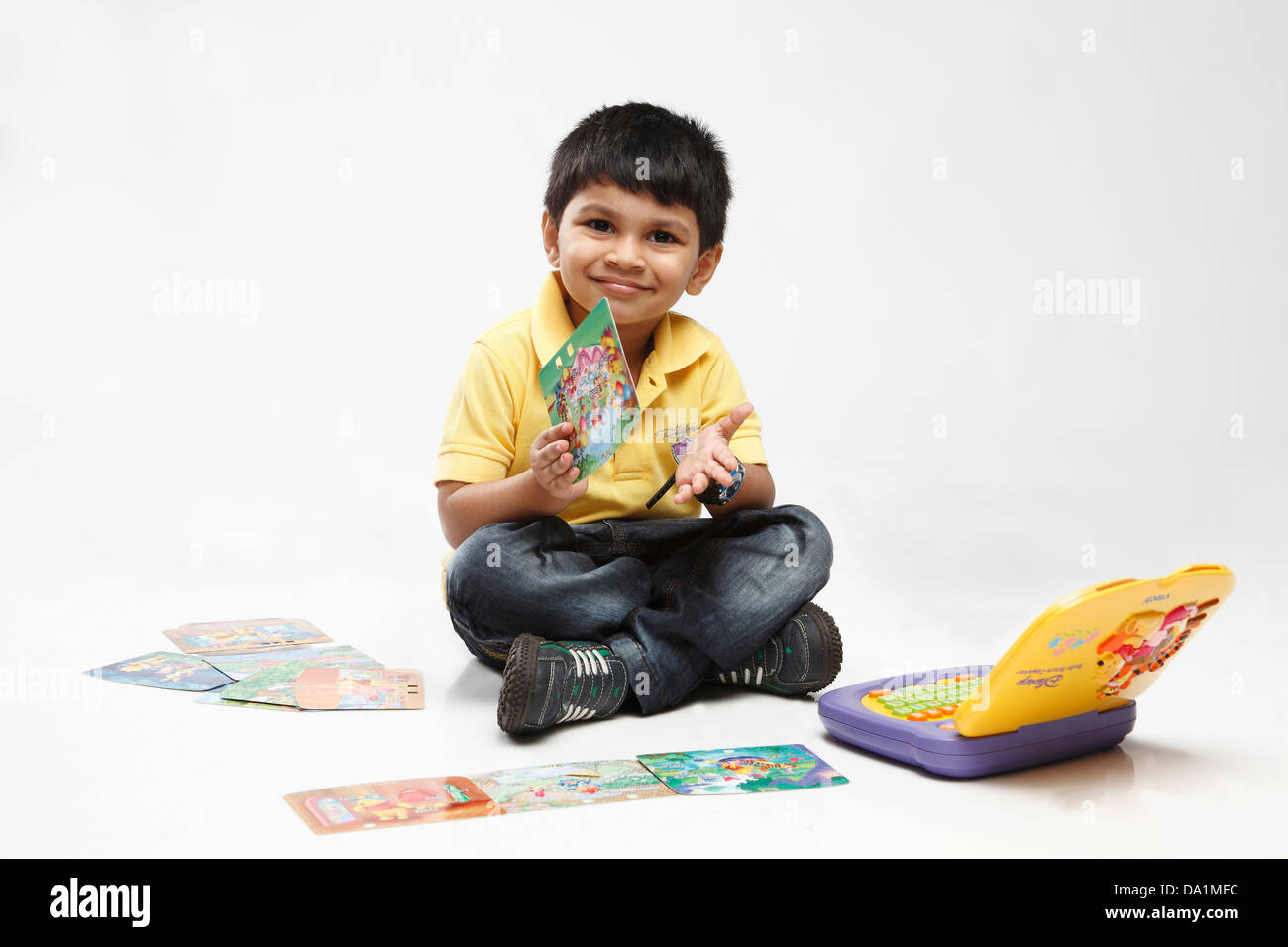 Little indian kid playing with laptop computer indoors Stock Photo - Alamy