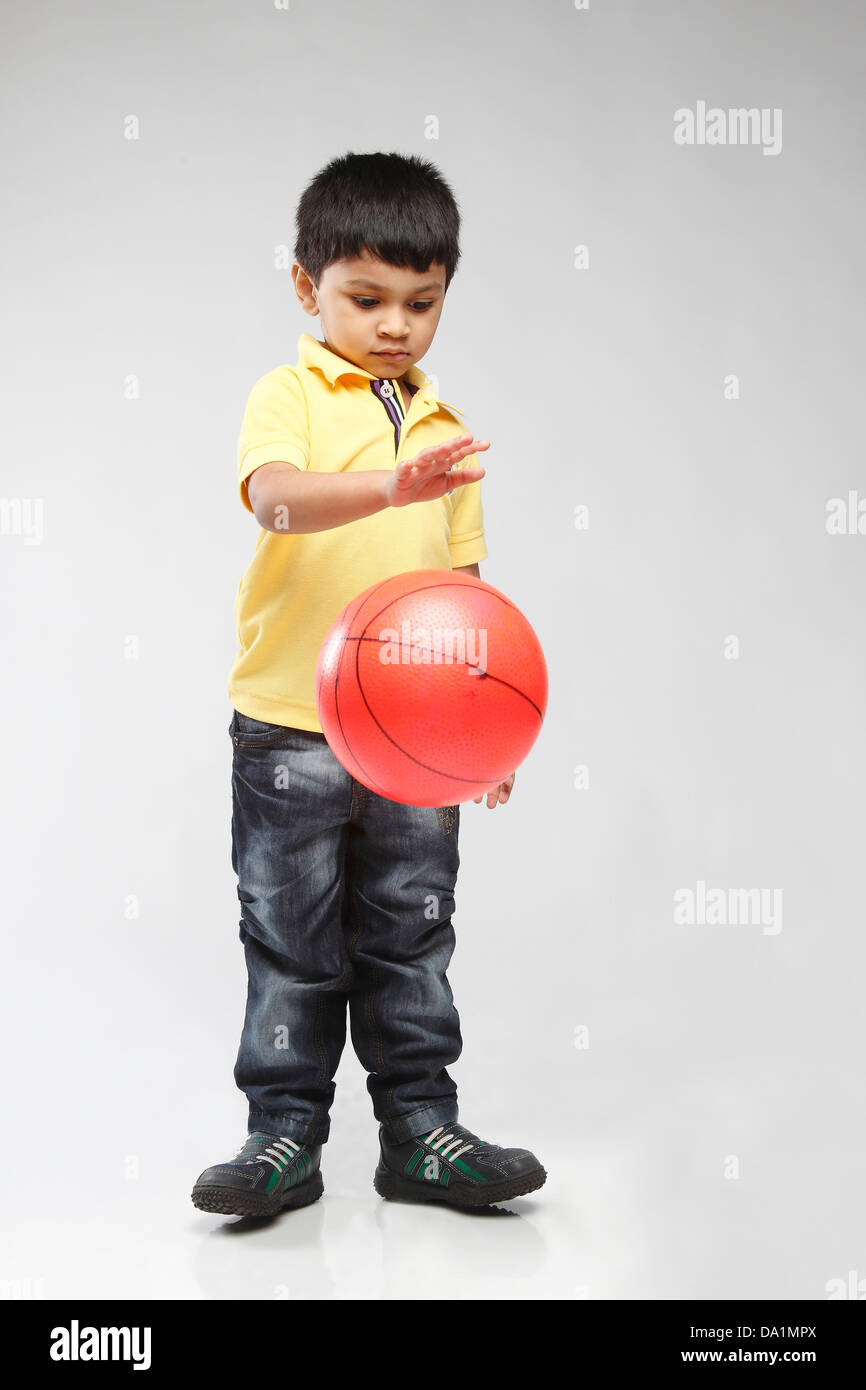 Little 5 year old Indian kid throwing up a ball Stock Photo Alamy