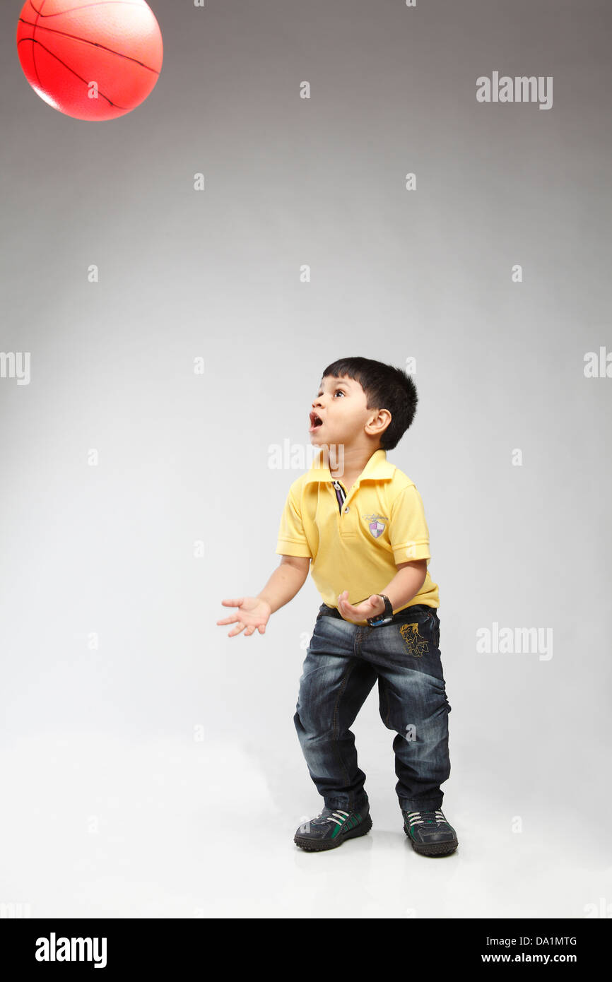 Little 5 year old Indian kid throwing up a ball Stock Photo Alamy