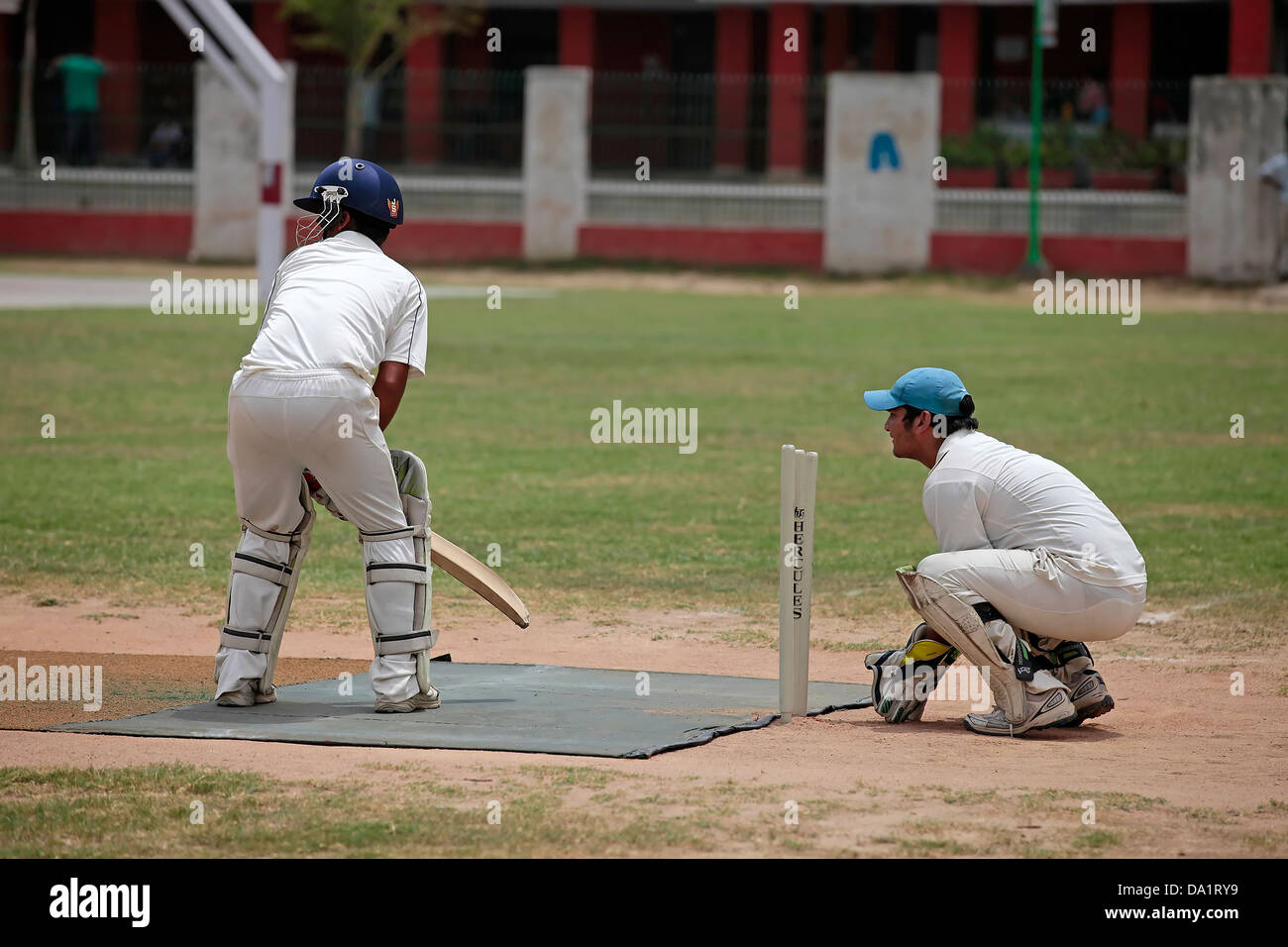 Batsman Hitting Ball During Cricket Match Stock Photo